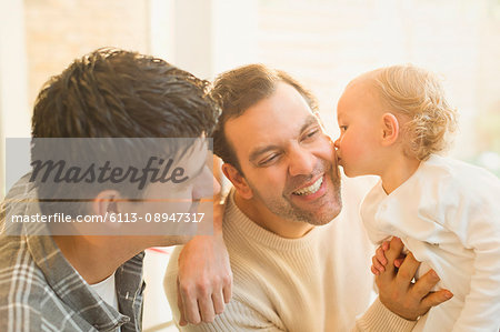 Affectionate baby son kissing male gay parents Affectionate baby son kissing male gay parents