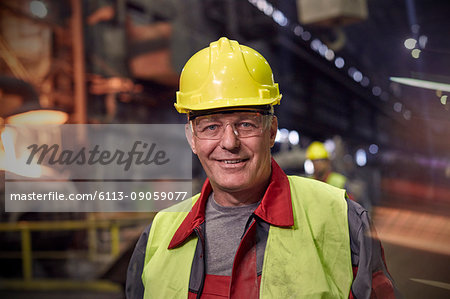 Portrait smiling, confident steelworker in steel mill