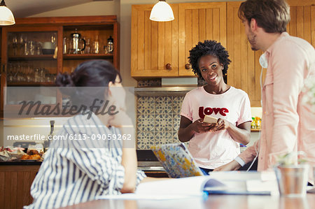 Friend roommates talking in kitchen