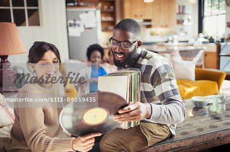 Couple looking at vinyl records in living room