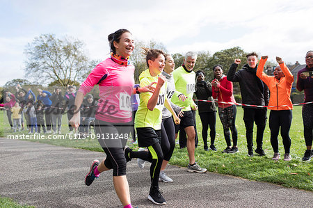 Enthusiastic family runners running in charity run at park