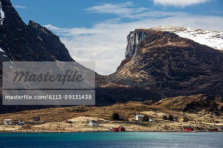 Mountains over remote seaside houses, Krystad, Lofoten, Norway