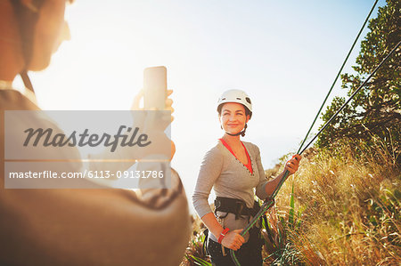 Female rock climber posing, being photographed