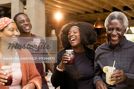 Happy multi-generation family drinking lemonade and sangria