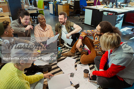 Creative business team meeting, brainstorming circle on office floor