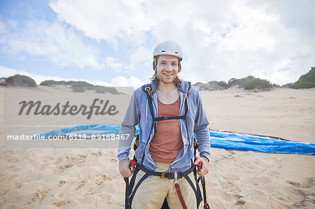 Portrait confident male paraglider on beach