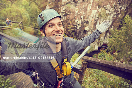 Portrait smiling, carefree man preparing to zip line