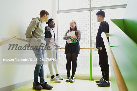 High school students talking on stair landing