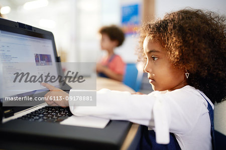 Curious girl using laptop