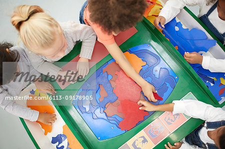 View from above kids playing at interactive exhibit in science center