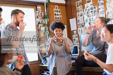 Creative business people eating in office