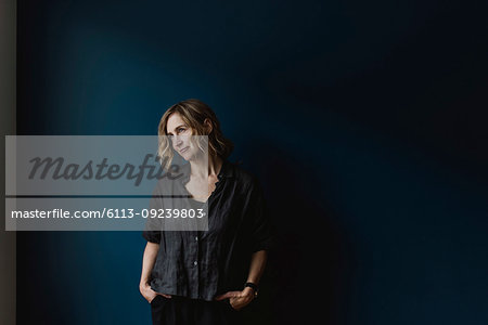 Thoughtful woman on blue background