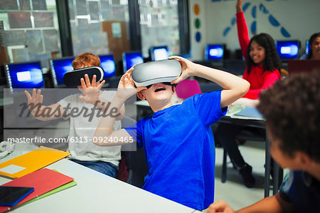 Junior high school boy students using virtual reality simulators in classroom