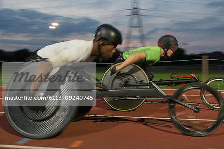Paraplegic athletes speeding along sports track in wheelchair race