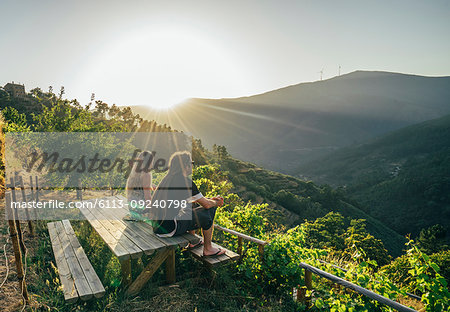 Couple enjoying sunny, idyllic hillside view, Chas de Egua, Portugal