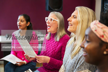 Womens choir singing in music recording studio