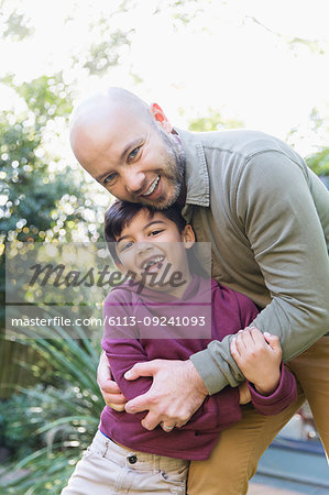 Portrait happy father and son hugging