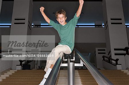 Boy Sliding Down A Banister Stock Photo Masterfile Premium