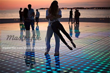 Croatia, Dalmatia, Solar panels as a dance floor, sunset in background