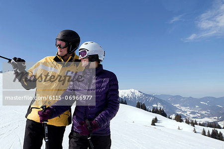 Young couple standing in a ski resort, Sudelfeld, Bavaria, Germany
