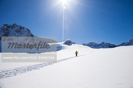 Skier walking across glacier, Stubai, Tyrol, Austria
