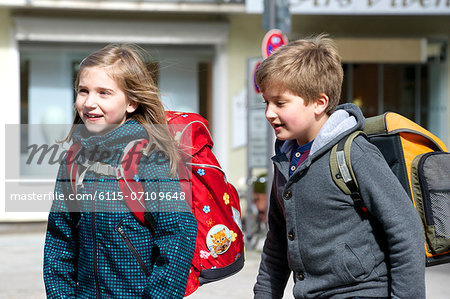 Two children walking to school, Munich, Bavaria, Germany