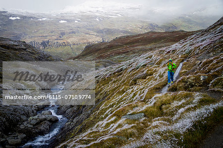 Man speed hiking along mountain trail, Norway, Europe