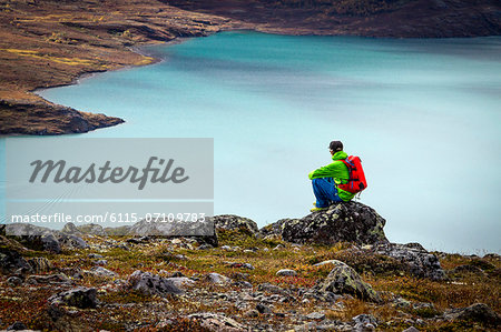 Hiker taking a rest a fjord, Norway, Europe