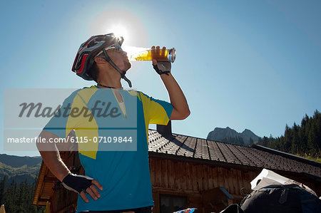 Mountain biker drinking a beer, Kleinwalsertal, Vorarlberg, Austria