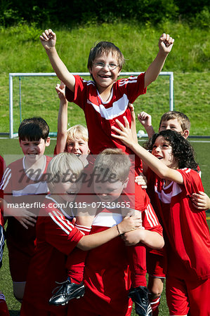 Group of boys at soccer training, cheering, Munich, Bavaria, Germany