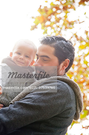 Man holding his son in autumn, Osijek, Croatia