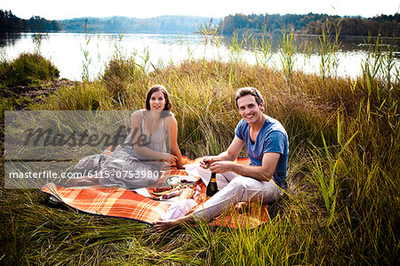 Young couple on the lakeside, having a picnic, Bavaria, Germany