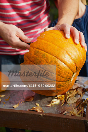 People carving Jack O'Lantern