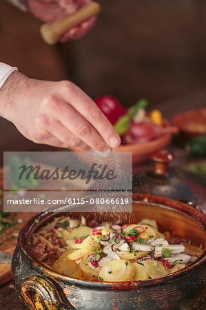 Unrecognizable person seasoning food Unrecognizable person seasoning food