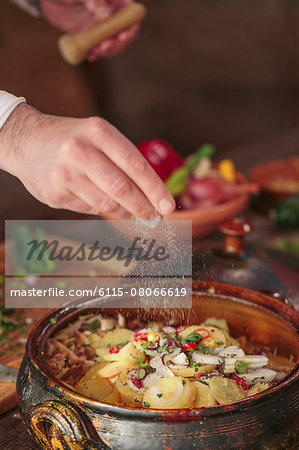 Unrecognizable person seasoning food