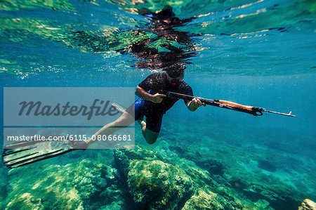 https://image1.masterfile.com/getImage/6115-08066681em-man-with-harpoon-adriatic-sea-dalmatia-croatia-stock-photo.jpg