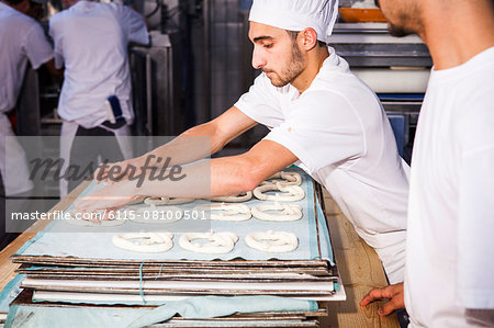 Bakers making pretzel dough in bakery