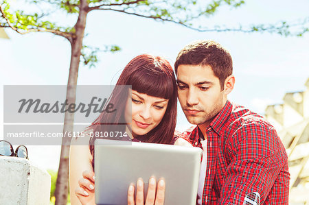 Young couple uses digital tablet outdoors, Osijek, Croatia