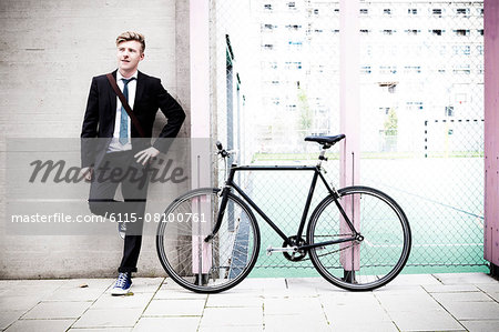 Young businessman with bicycle taking a break, Munich, Bavaria, Germany
