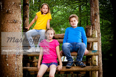 Children sitting on a tree house,  Munich, Bavaria, Germany