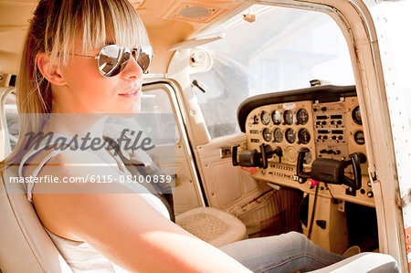 Young woman preparing  for start in private airplane