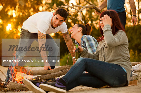 Group of friends by campfire having fun, Osijek, Croatia
