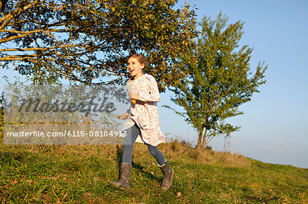 Girl running in field