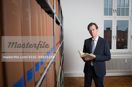 Lawyer with book in office