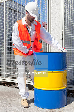 Engineer checking metal drum in electricity substation