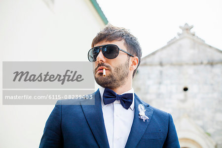 Bridegroom with sunglasses and cigarette
