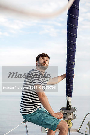 Man listening to music on sailboat, Adriatic Sea