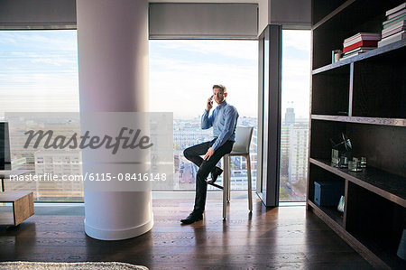 Businessman in apartment on the phone