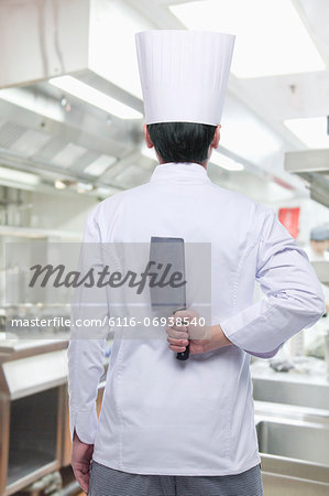 Rear View of Chef with Knife Behind his Back
