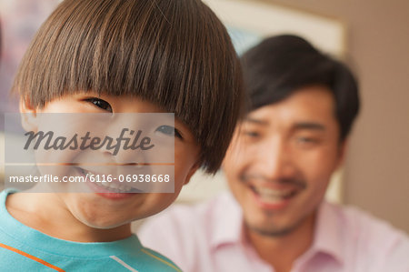 son with father smiling, portrait